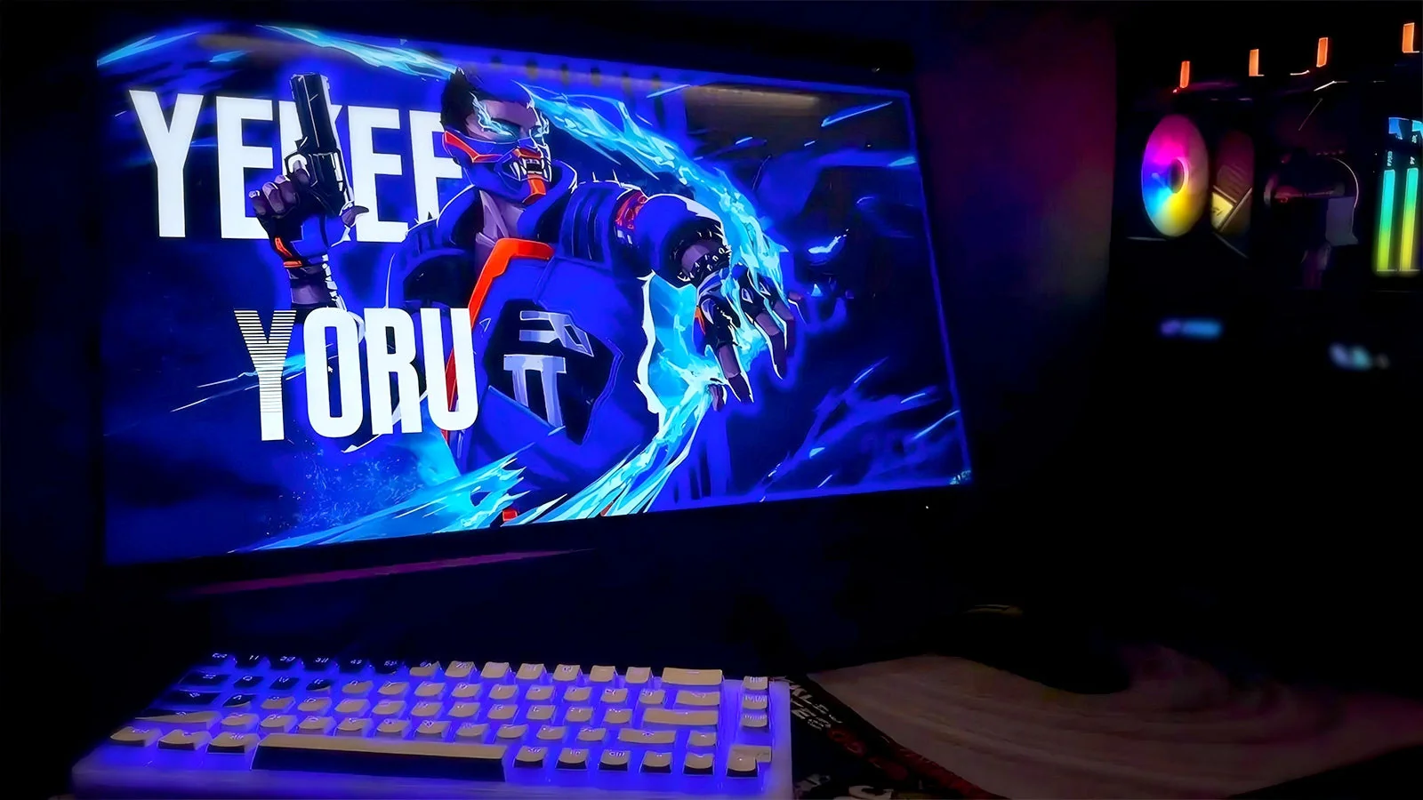 Dark gaming room setup with glowing keyboard, mouse, and professional microphone for comms